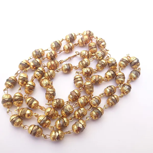 https://d1311wbk6unapo.cloudfront.net/NushopCatalogue/tr:f-webp,w-600,fo-auto/Trendeela.com_Fiona_Yellow_Gold_Plated_Chain_Encrusted_With_Brown_Beads_YRT0UA3UFI_2022-11-13_1.JPG__Trendeela